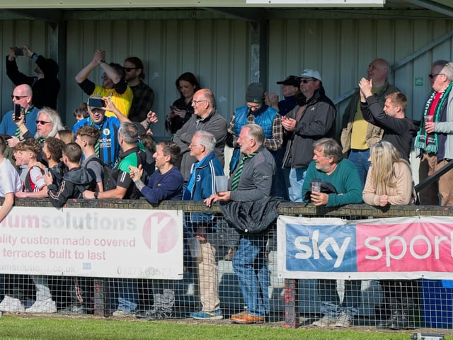 Burgess Hill Town players, fans and staff celebrate surviving in the Isthmian south east division at the end of their 0-0 draw with Beckenham