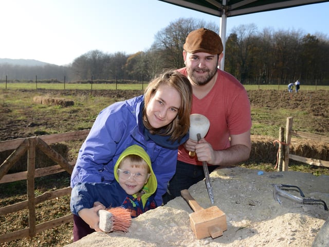 Elliot Apps helps his mum Alison Stevens and Toby West carve the stone sculpture