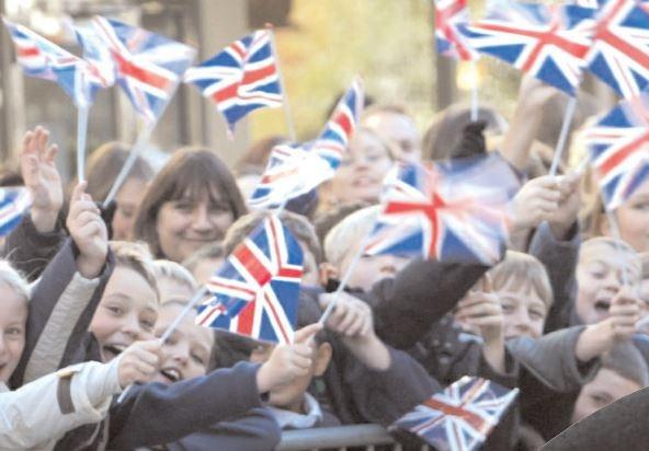 The patriotic crowd wave their flags