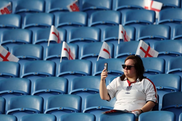 An England fan takes their seat inside the stadium.
