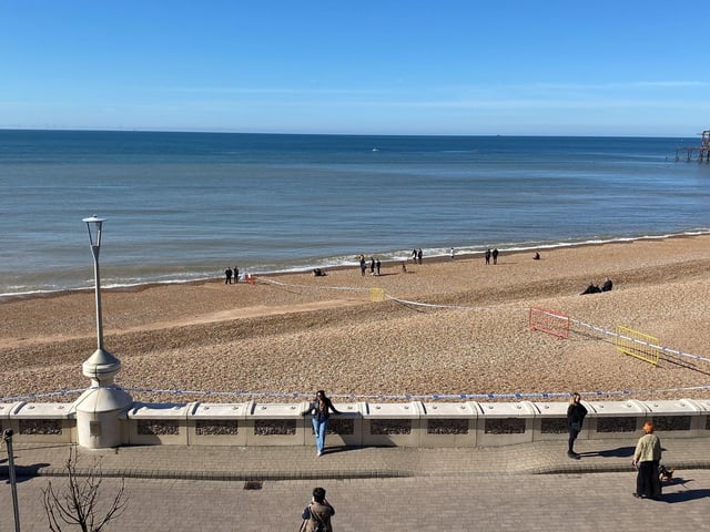 Police officers have taped off a section of Brighton beach after the discovery of a 'suspected mine'