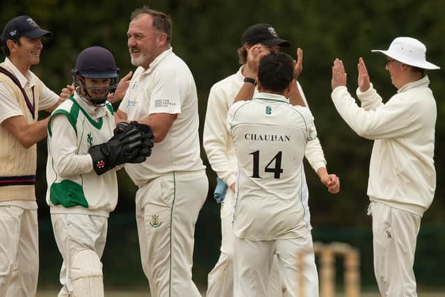 West Wittering 2nd XI captain Kev Allsobrook (centre) celebrates taking his 1000th wicket with his team-mates - in a match ended early by rain | Picture: Chris Hatton
