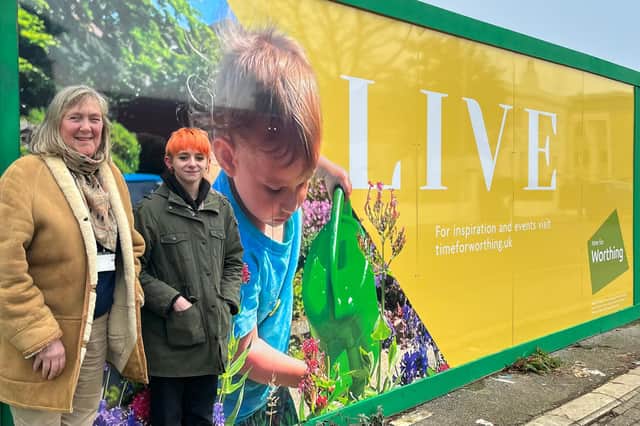 Councillor Rita Garner, left, and Tia Phillips in front of the hoarding featuring Tia’s photo