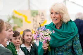 CHARLESTON, UNITED KINGDOM - MAY 16: Britain's Queen Camilla receives flowers as she makes a surprise appearance at the opening session of the Charleston Festival in Charleston in Firle on May 16, 2024 in Charleston, England. The Queen joins this year's opening event called the 'Power of Reading', aiming to celebrate the power of books and reading for children and young people. (Photo by Kirsty Wigglesworth - WPA Pool/Getty Images)