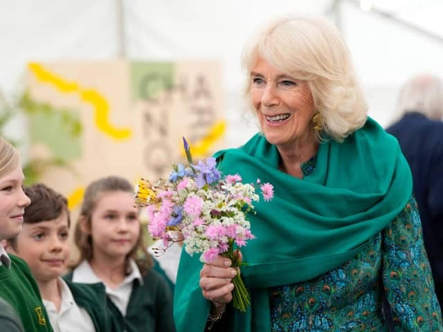 CHARLESTON, UNITED KINGDOM - MAY 16: Britain's Queen Camilla receives flowers as she makes a surprise appearance at the opening session of the Charleston Festival in Charleston in Firle on May 16, 2024 in Charleston, England. The Queen joins this year's opening event called the 'Power of Reading', aiming to celebrate the power of books and reading for children and young people. (Photo by Kirsty Wigglesworth - WPA Pool/Getty Images)