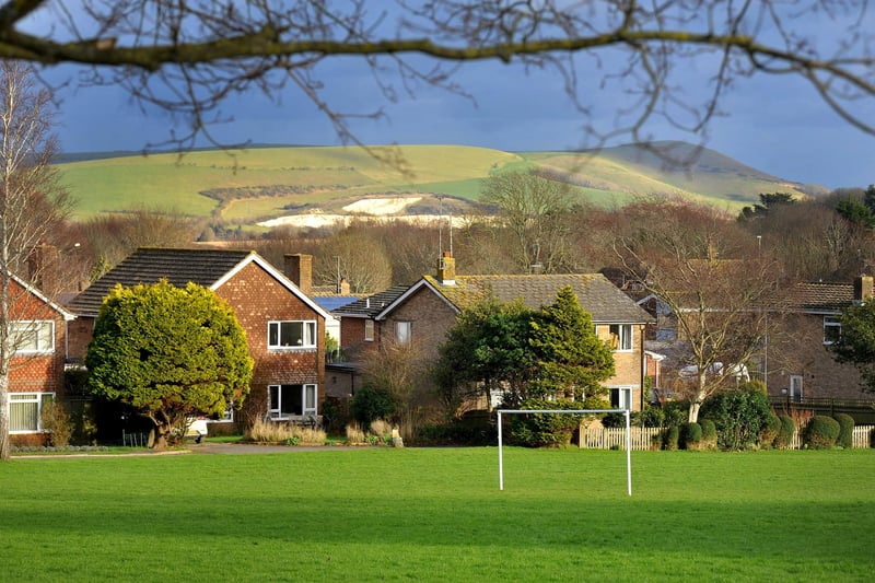 The village is mentioned in the Domesday Book and is located two miles (3.2 km) south of Lewes .