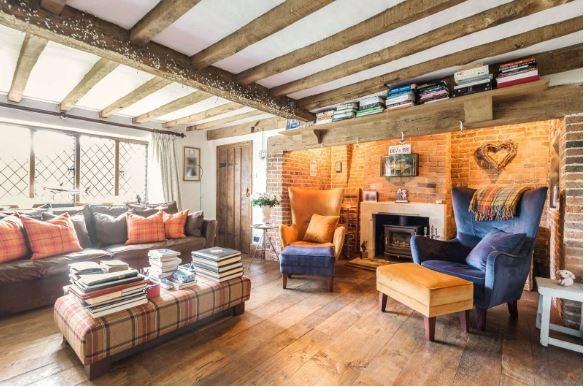 The drawing room has a stone fireplace with a Chesneys wood burning stove set into a handsome brick inglenook.