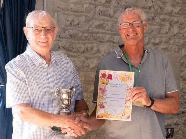 Chairman Chris Smith with Colin Crane, who won the Ray Brown Memorial Shield and David Mackenzie Thorowgood Memorial Cup for sweet peas