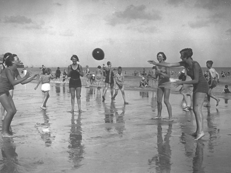 Young holidaymakers playing ball on the beach at Eastbourne in 1930.