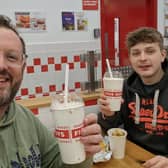 Sussex World's Mark Dunford and son Noah try out the new milkshake flavours at Five Guys | Picture: Sussex World