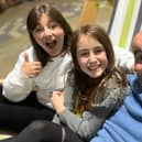Horsham schoolgirl Laila Cronin, left, pictured with one of her sisters and her dad. Laila is raising funds for a 'once-in-a-lifetime experience'.