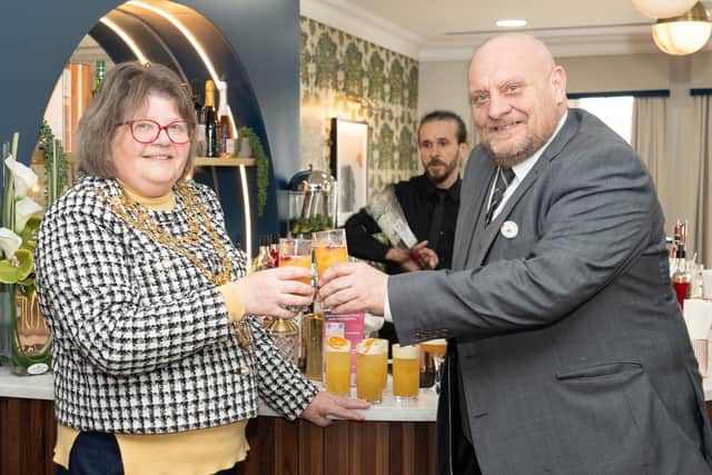 Cllr Candy Vaughan and General Manager Ian Cole celebrate Willingdon Park Manor opening with a cocktail.