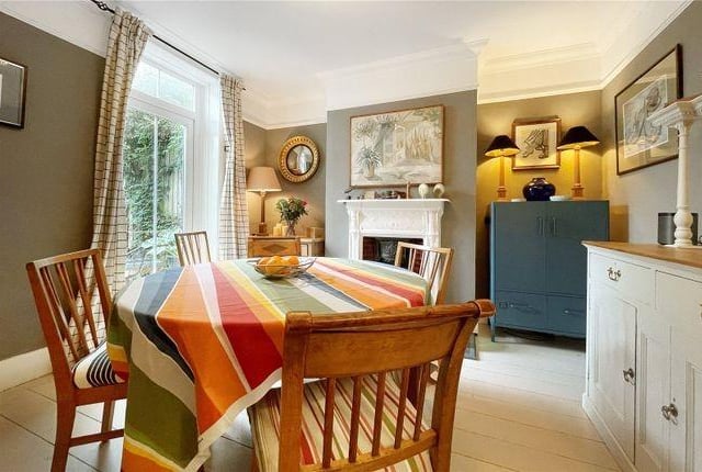 The dining room is separate from the kitchen and benefits from a working fireplace.