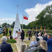 Crowds gather at the Polish Airmen’s memorial at Plumpton on Sunday.