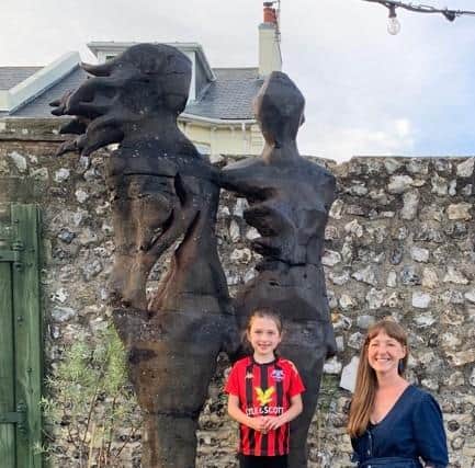 Young Rooks fan Izzy Currie and sculptor Amanda Cotton with the statue