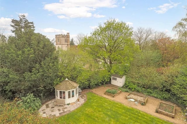 The property has a side garden with summer house, rose-clad pergola and views of the parish church.