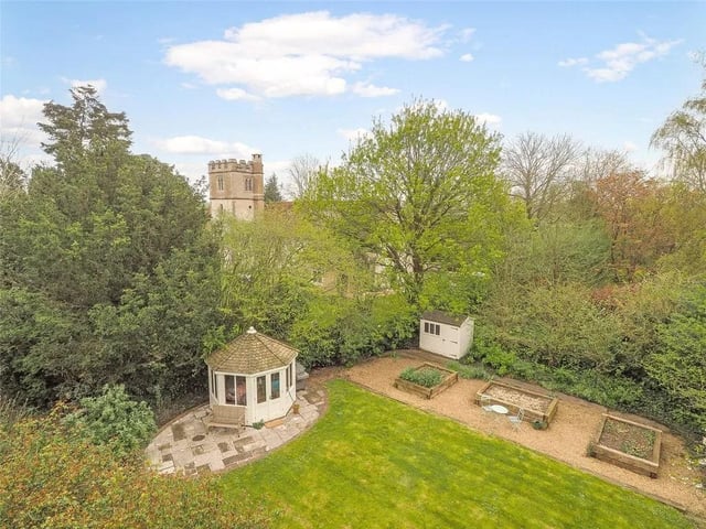 The property has a side garden with summer house, rose-clad pergola and views of the parish church.