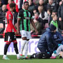 Kaoru Mitoma of Brighton & Hove Albion receives medical treatment after being fouled by Mason Holgate of Sheffield United | Picture: Getty