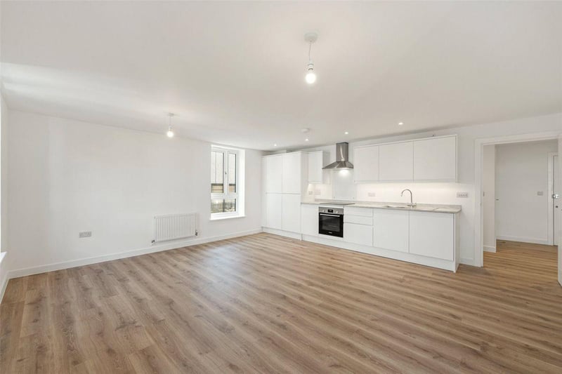 One two-bedroom apartment with balcony on the second floor is priced at £295,000. It has a light and spacious hallway and open-plan living / dining / kitchen area.
