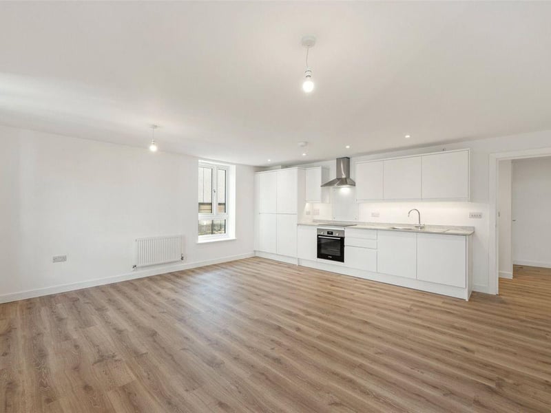 One two-bedroom apartment with balcony on the second floor is priced at £295,000. It has a light and spacious hallway and open-plan living / dining / kitchen area.