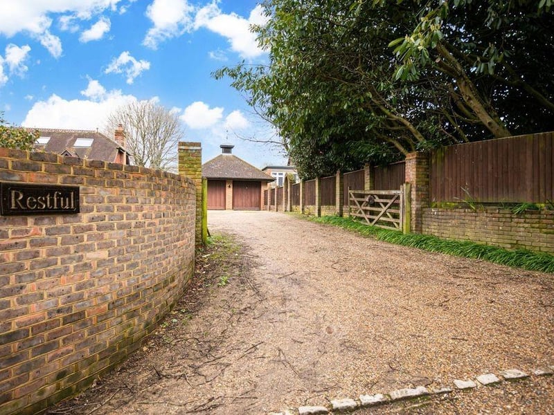 Detached double garage with expansive driveway