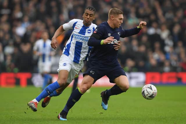 Martyn Waghorn of Derby County is held by Bernardo of Brighton & Hove Albion during the FA Cup fifth round match