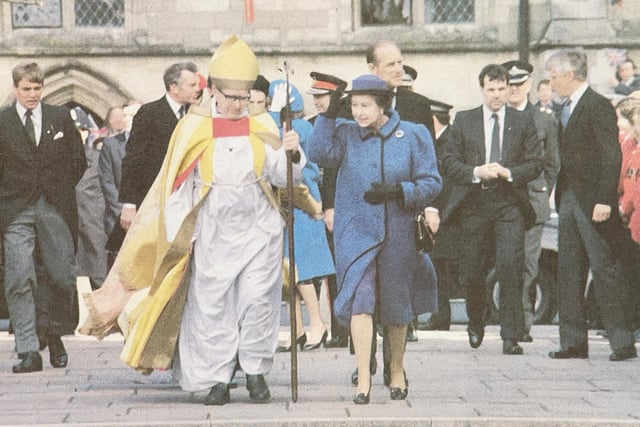 The Queen leaves the Cathedral with the Bishop of Chichester Eric Kemp.