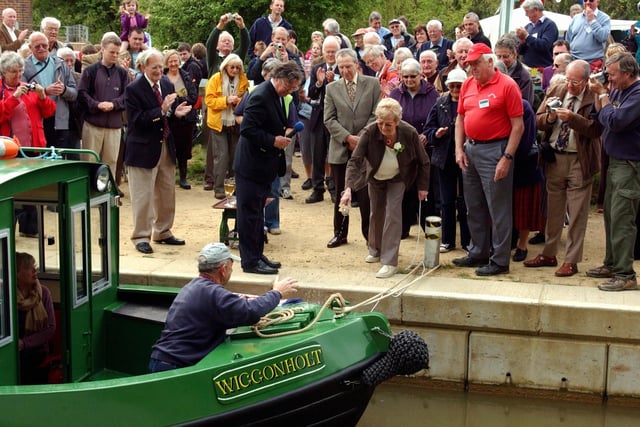 The naming of the new all-electric trip boat, Wiggonholt, by Mrs Doreen Mann, who poured a glass of champagne over it to mark the occasion