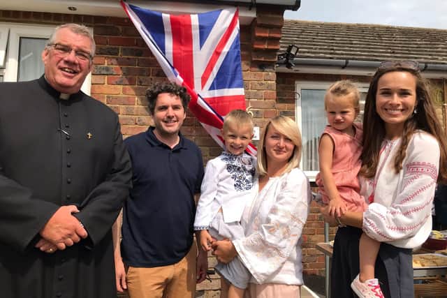 Fr Robert Coates, vicar of St Augustine’s, Bexhill MP, Huw Merriman, together with Ukrainian nationals Olena and her son Andri and Natalia and her daughter Sofia