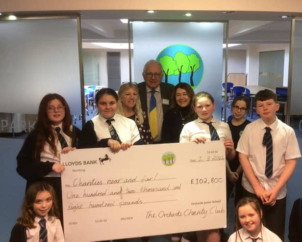 Worthing West MP Sir Peter Bottomley presents a giant cheque for £102,800 to Orchards Junior School's Charity Club