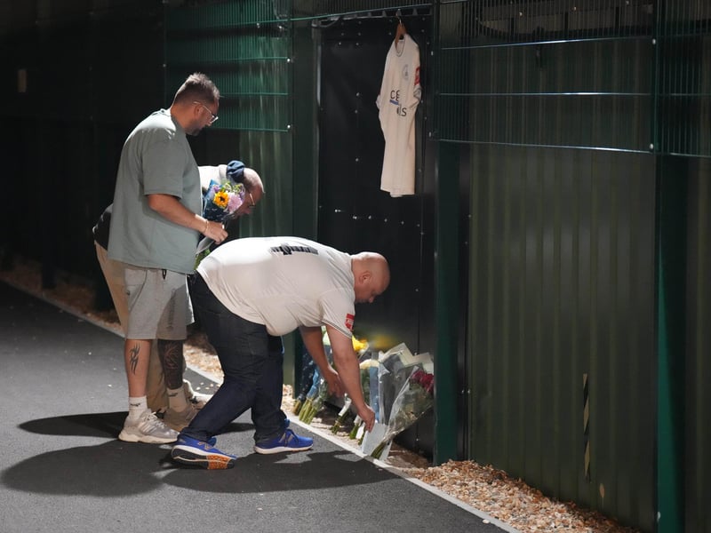 Chichester City FC and former Arsenal academy striker Billy Vigar has died after sustaining a "significant brain injury".
Vigar, 21 and born in Worthing, was injured during a game at Wingate and Finchley on Saturday in the Isthmian League Premier Division.
It is thought the injury was caused when he collided with a concrete wall, but the club has not confirmed this.
Vigar's family said on Thursday they were "devastated that this has happened while he was playing the sport he loved".
"After sustaining a significant brain injury last Saturday, Billy Vigar was put into an induced coma," the family said.
"On Tuesday, he needed an operation to aid any chances of recovery. Although this helped, the injury proved too much for him and he passed away on Thursday morning.
"The responses to the original update show how much Billy was loved and thought of within the sport." : Floral tributes to Billy Vigar are left at Chichester City FC