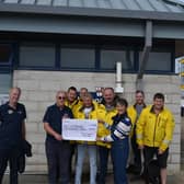 Eastbourne’s RNLI was presented with a cheque of £2,000 by a member of the public who wing walked in aid of the charity. Picture: RNLI