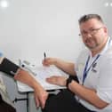 Councillor Chris Mullins (left) has his blood pressure checked by Sam Lusted, wellbeing advisor. Picture contributed