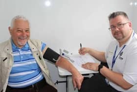 Councillor Chris Mullins (left) has his blood pressure checked by Sam Lusted, wellbeing advisor. Picture contributed
