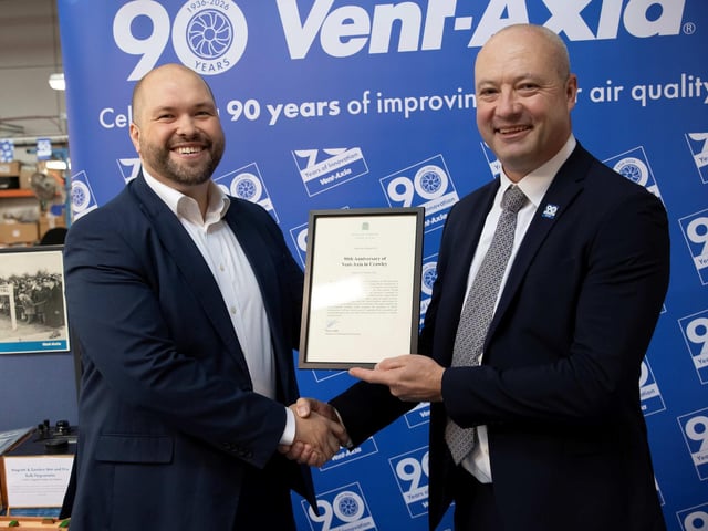 Peter Lamb, MP for Crawley, presented Graham Sanders, managing director at Vent-Axia, with a framed copy of Early Day Motion 918 tabled in the House of Commons on October 12, 2026, congratulating the company on its 90th anniversary