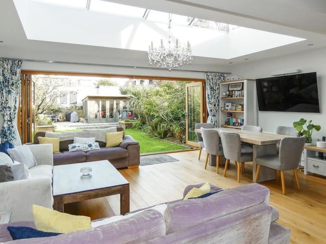 The outstanding family room encompasses a stylish open-plan kitchen, feature roof lantern and bifold doors