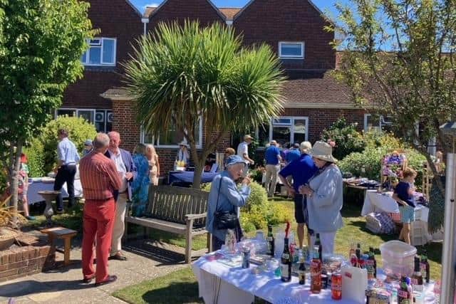 Residents, staff and guests enjoying the garden party.