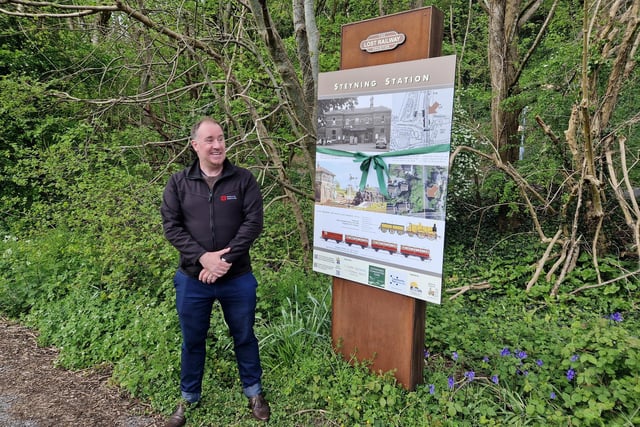 Russell Barnes, chairman of Steyning and District Community Partnership's visitor and tourism group, with the board on the side of the A283 Steyning bypass, just north of The Street, close to the site of Steyning Railway Station