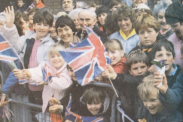 Residents wave their Union Jack flags in preparation for the Queen and Prince Philip.