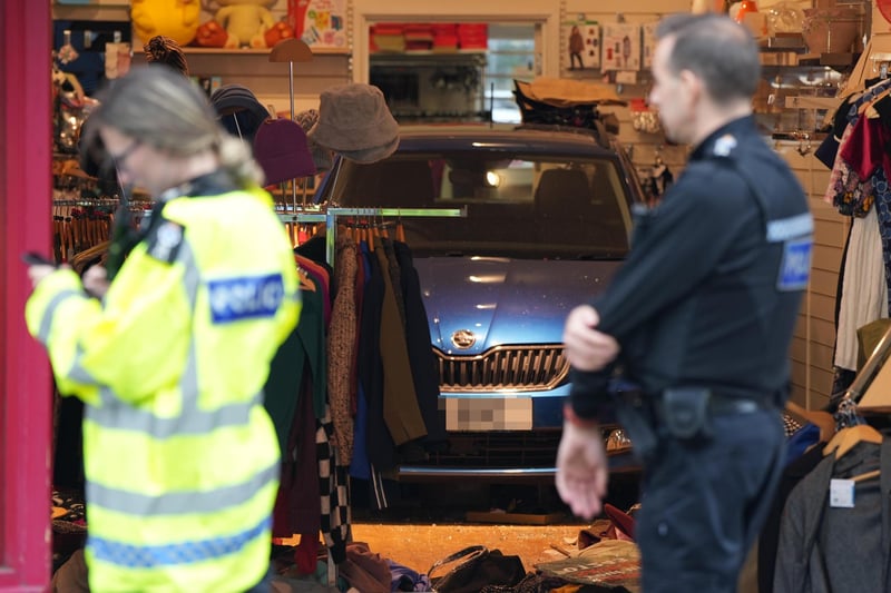 Trapped person rescued after car collides with Chichester charity shop.
