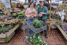 Pictured: Laura Litchfield from Brighton Refuge collecting the donation of plants from Clive Gravett, founder of the Budding Foundation. 