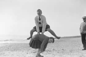 March 1929:  A couple of young women playing leap frog on the beach at Hove.