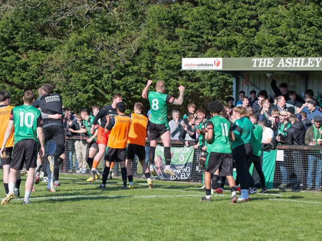 Burgess Hill Town players, fans and staff celebrate surviving in the Isthmian south east division at the end of their 0-0 draw with Beckenham