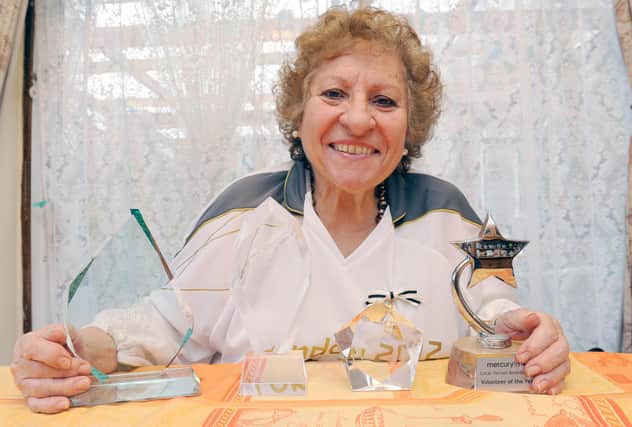 Maria Haines with various awards. Photo by Derek Martin