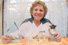 Maria Haines with various awards. Photo by Derek Martin