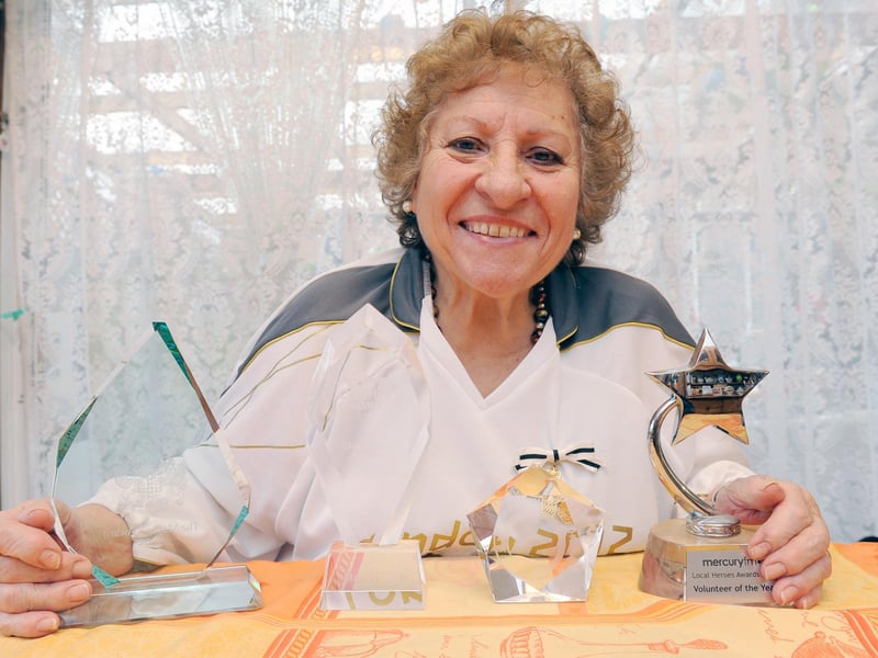 Maria Haines with various awards. Photo by Derek Martin