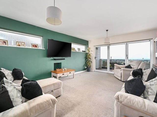 The living room is south facing and leads to a balcony