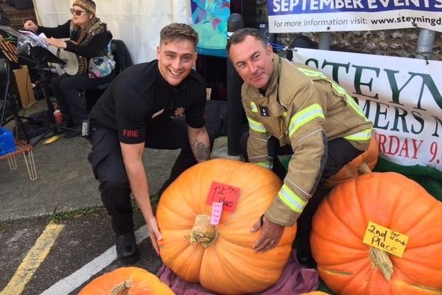 Steyning firefighters judged the weight of the pumpkins - and it took two to pick up the winner!