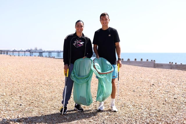 EASTBOURNE, ENGLAND - JUNE 25: Ons Jabeur of Tunisia and Ryan Peniston of Great Britain pose for a photo after participating in a beach clean on Eastbourne seafront during Day Two of the Rothesay International Eastbourne at Devonshire Park on June 25, 2023 in Eastbourne, England. (Photo by Charlie Crowhurst/Getty Images for LTA):Images from day two at the Rothesay tennis international at Devonshire Park, Eastbourne