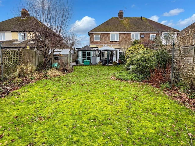 The south-facing garden has a patio and generous lawn
